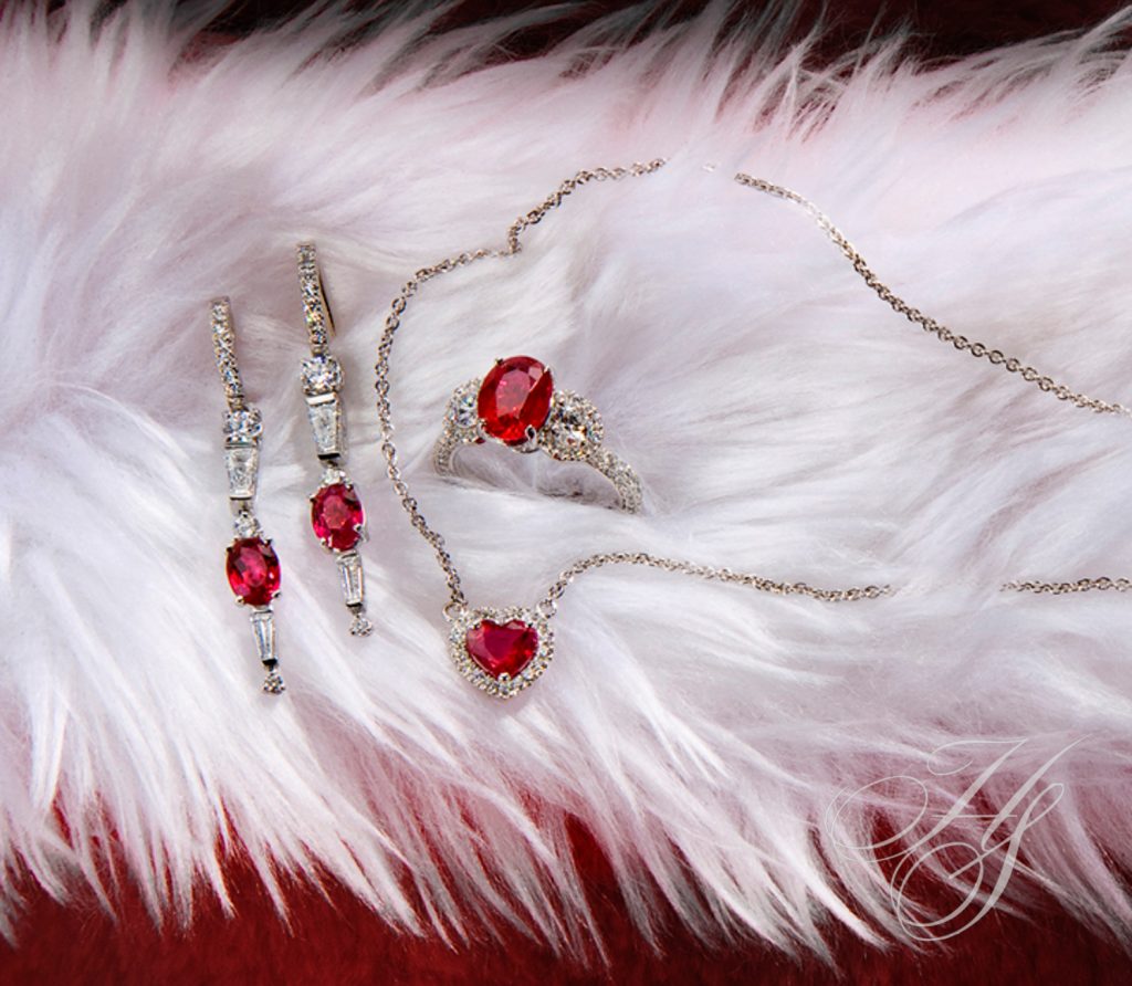 A white fur with some red jewelry on it