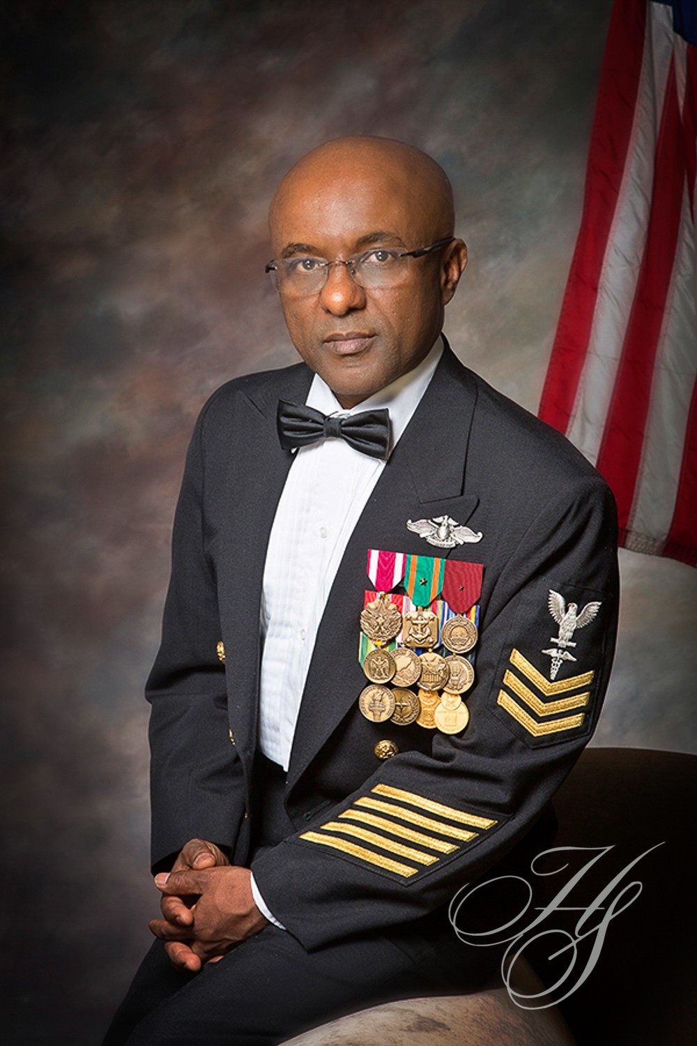 A man in military uniform with medals on his arm.