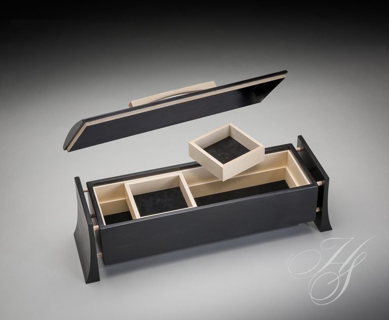 A black box with a lid and two compartments.