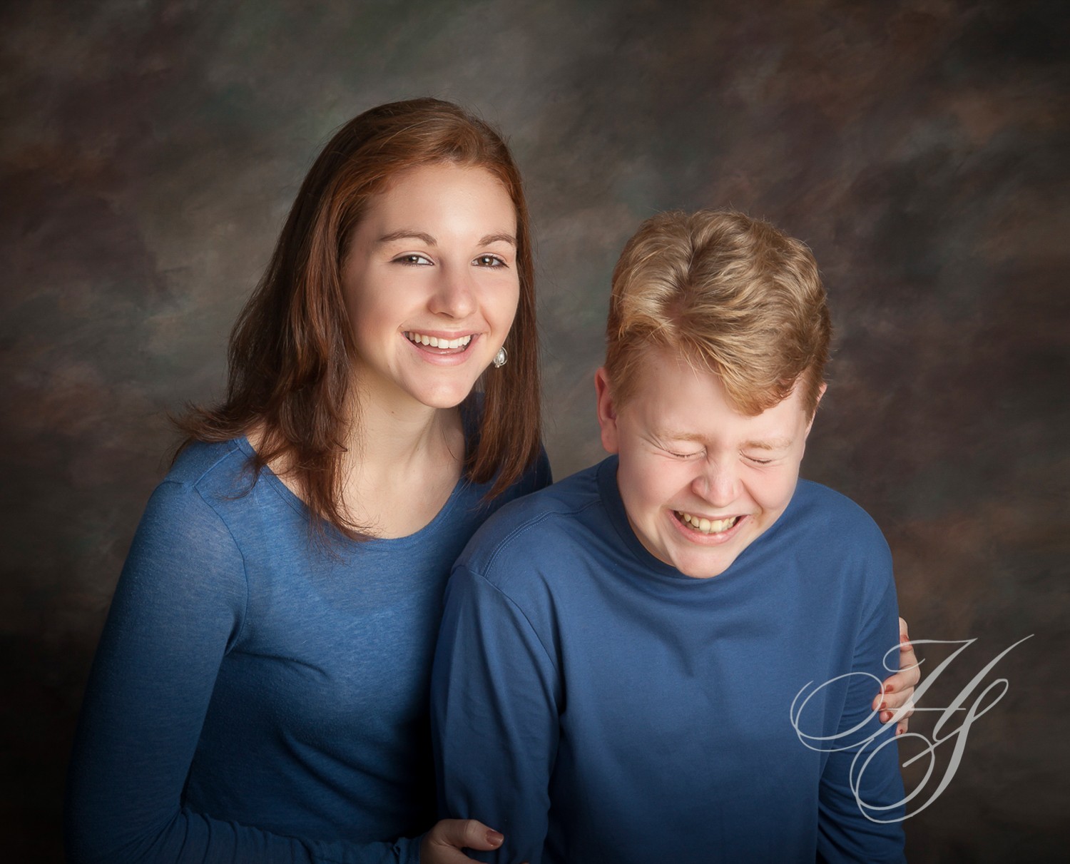 A young boy and girl posing for a picture.