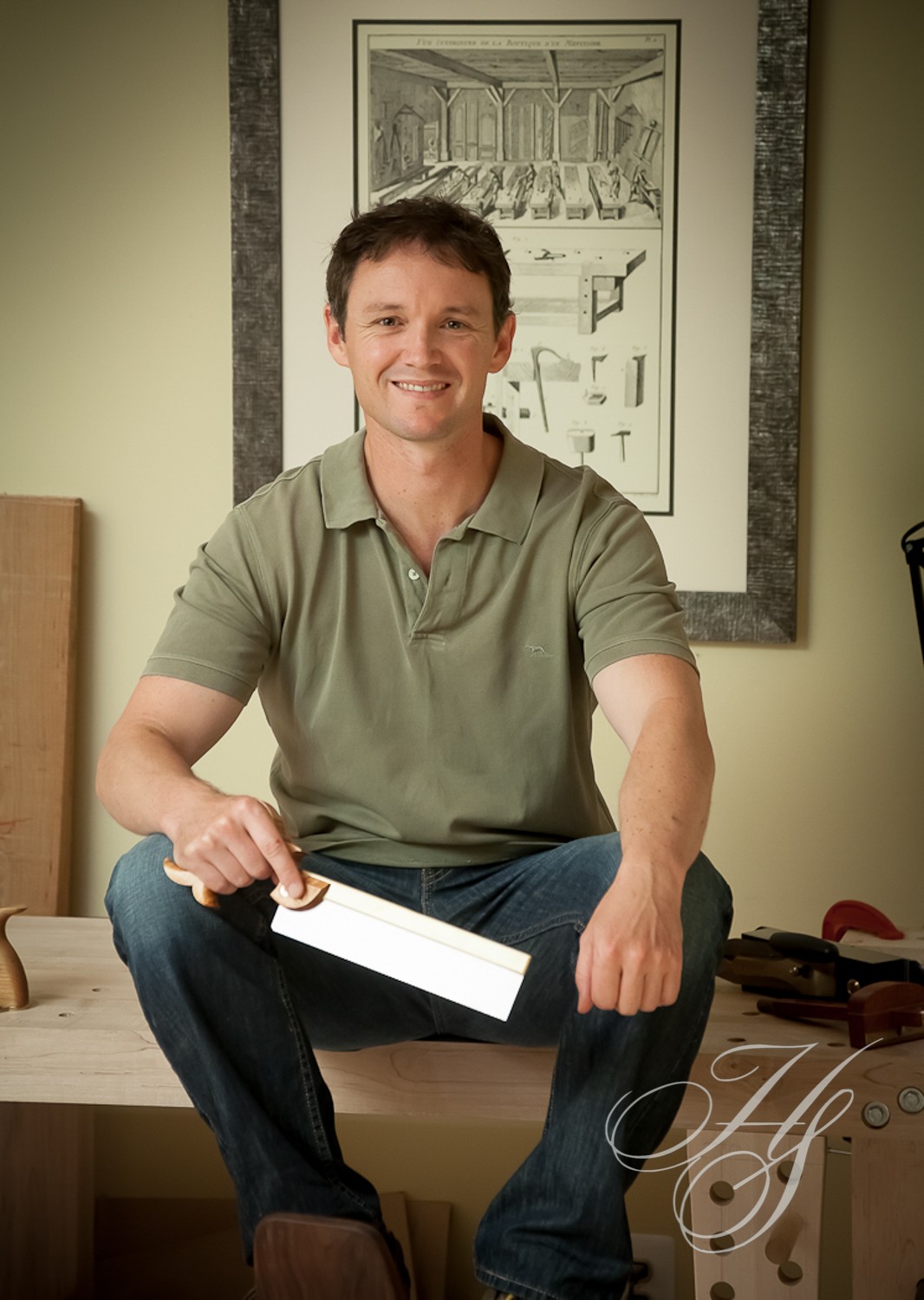 A man sitting on the floor holding a knife.