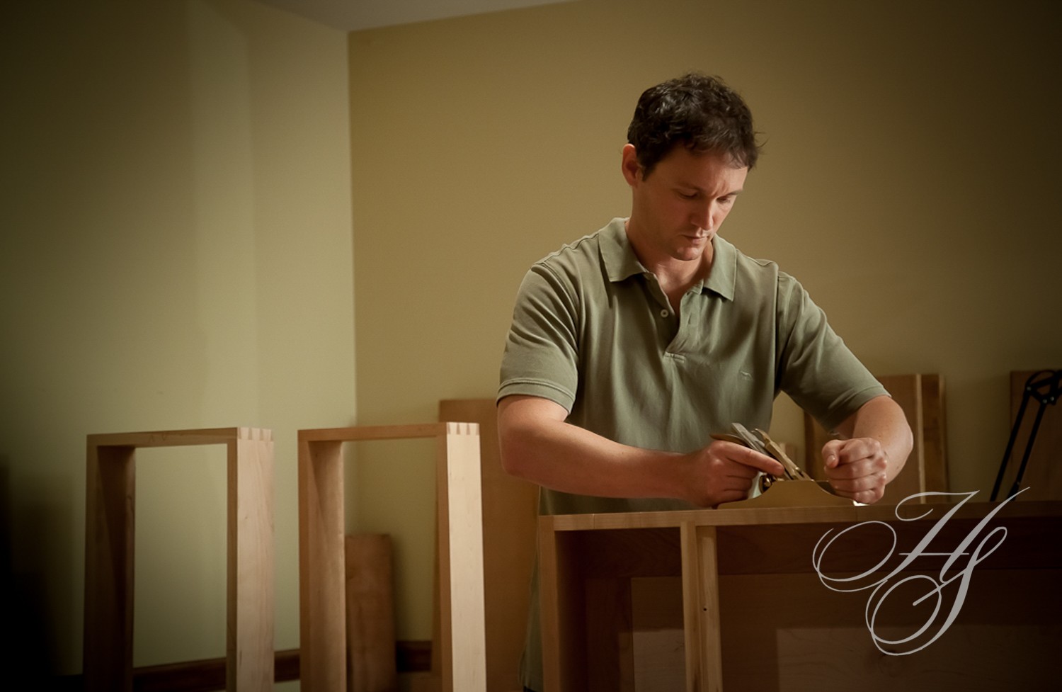 A man working on some wood in his workshop