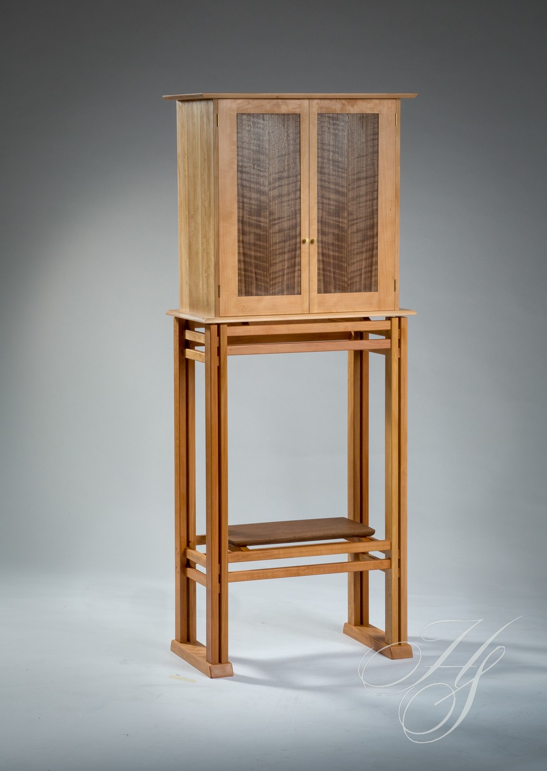 A tall wooden cabinet with two doors and a shelf.