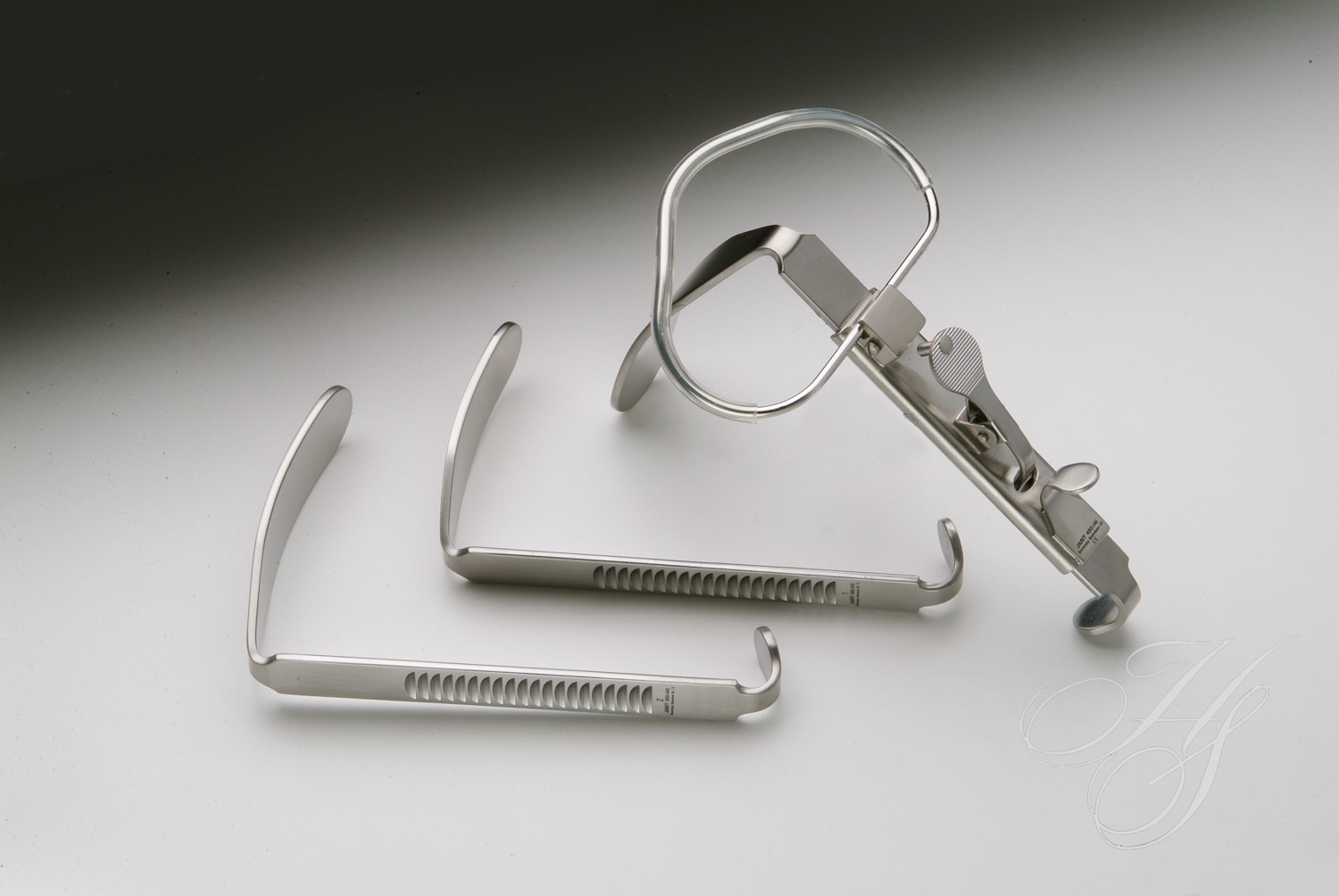 A pair of scissors and two pairs of tweezers.