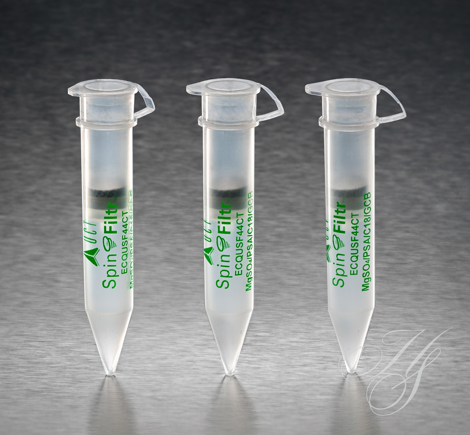 A group of three test tubes with green labels.