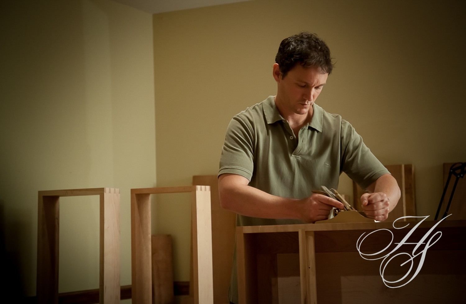 A man is working on some furniture in his room.