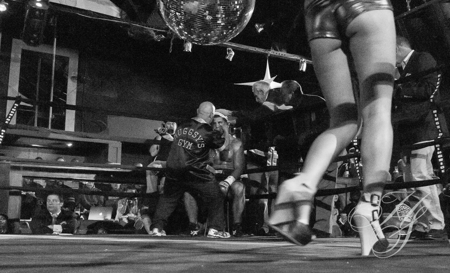 A man sitting on the ground in front of two women.