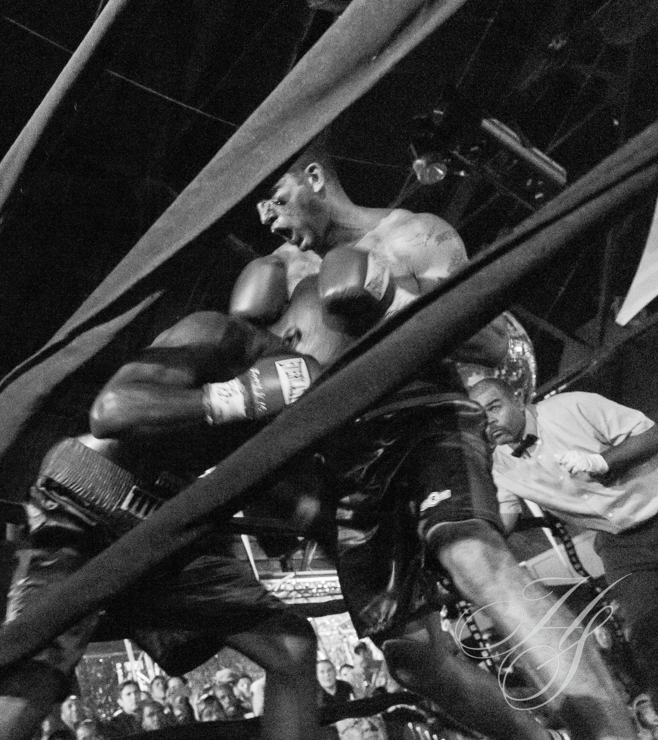 A black and white photo of two boxers in the ring.