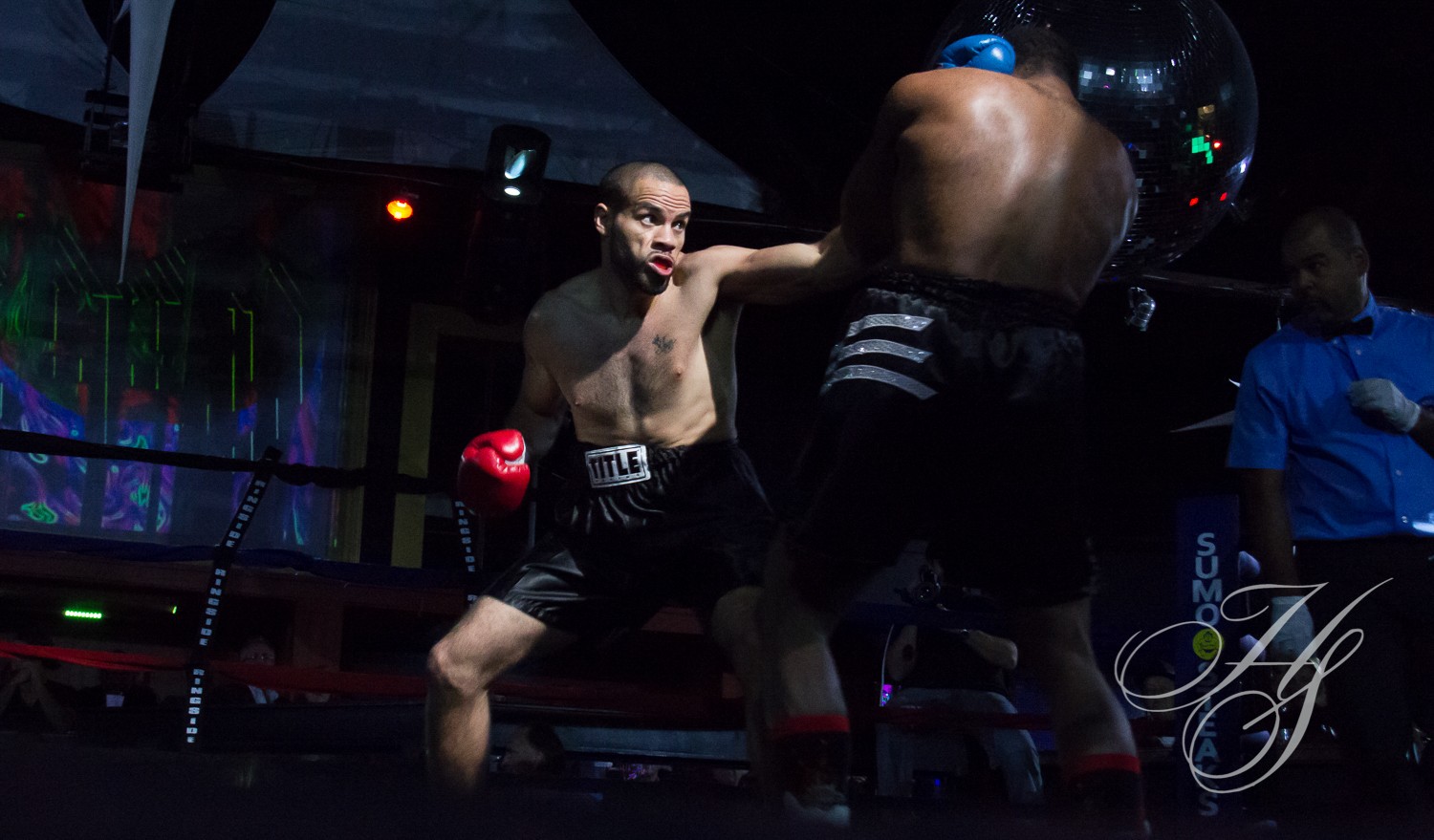 Two boxers in the ring during a match.