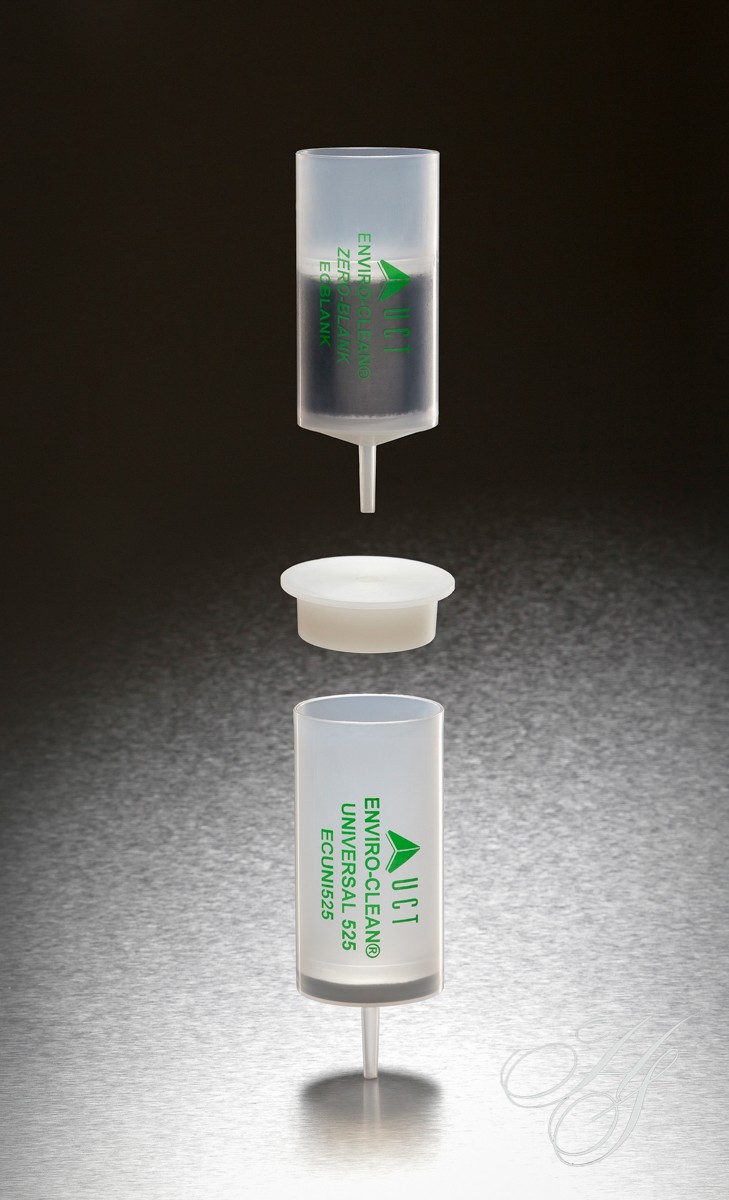 A small container with a green liquid inside of it.