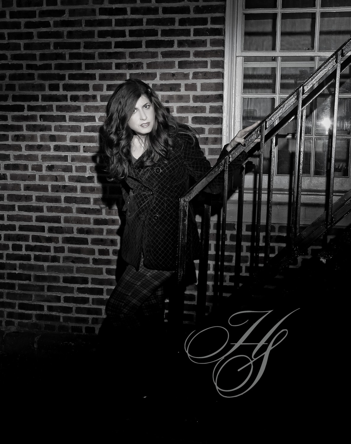 A woman standing on the stairs of a house.