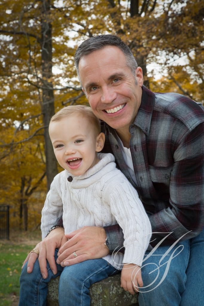 A man and his son are smiling for the camera.