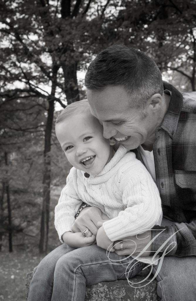 A man and his son are smiling for the camera.