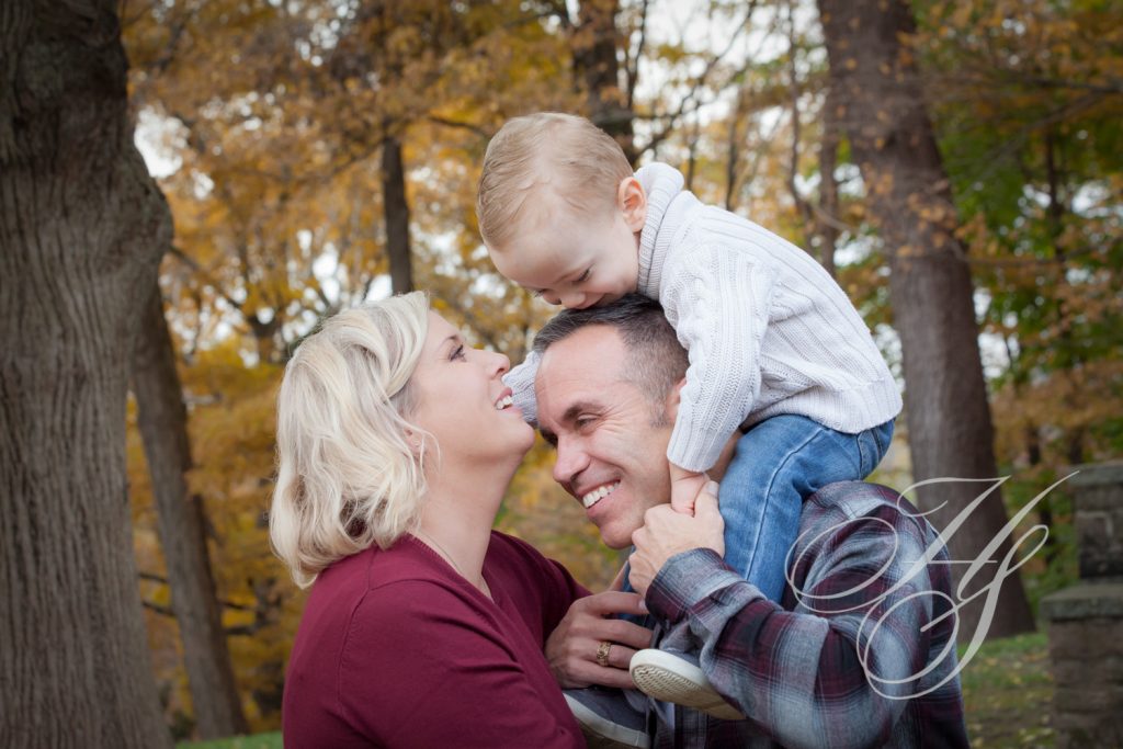 A man and woman holding a child in the air.