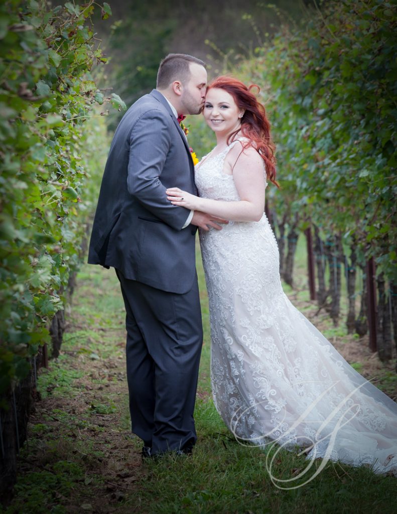 A man and woman in wedding attire standing next to each other.