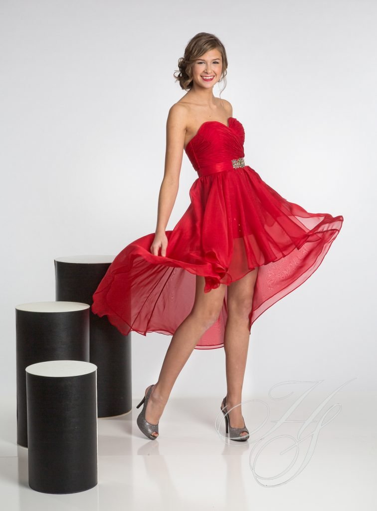 A woman in red dress posing for the camera.