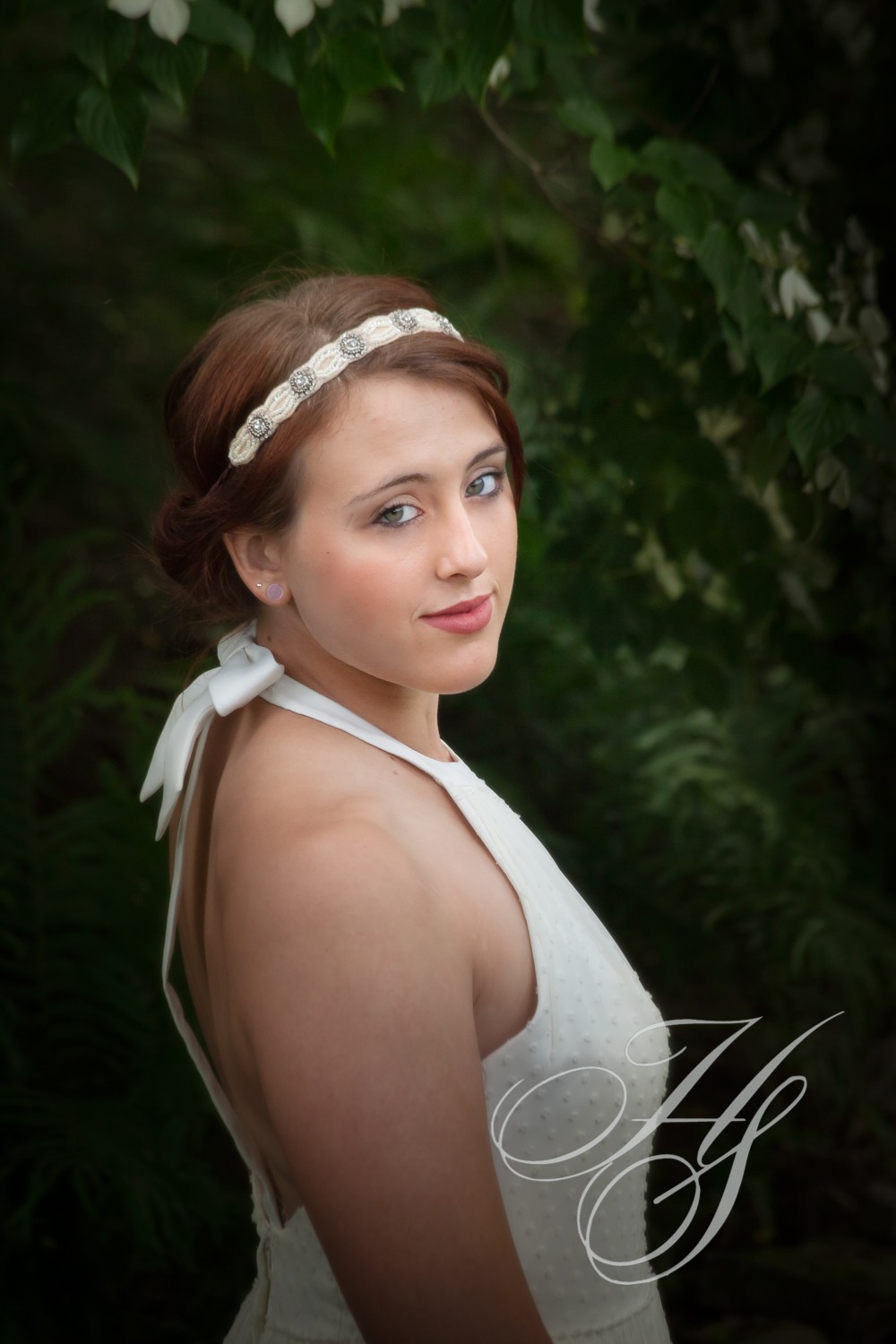 A beautiful young lady wearing a white dress.