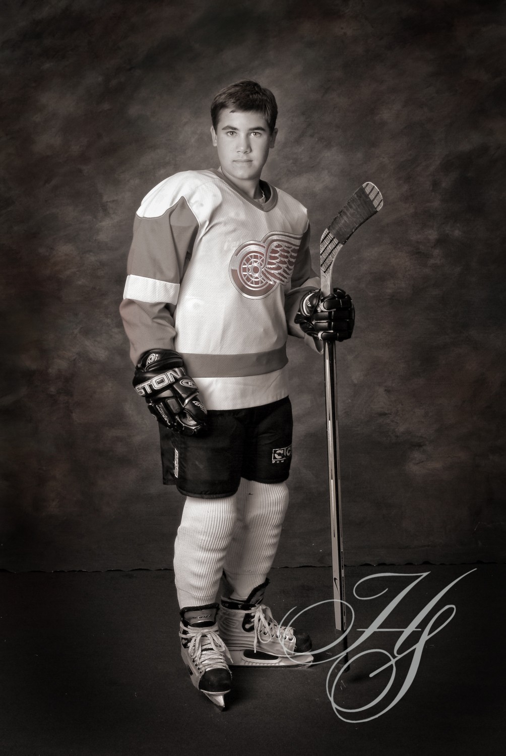 A man in hockey uniform holding a stick.