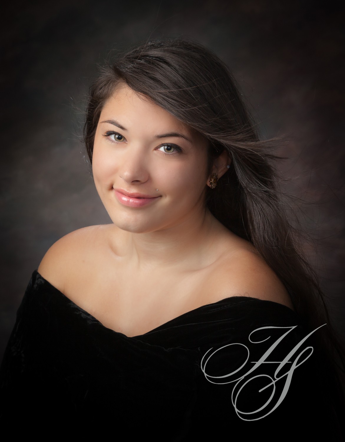 A beautiful young lady wearing a black dress.