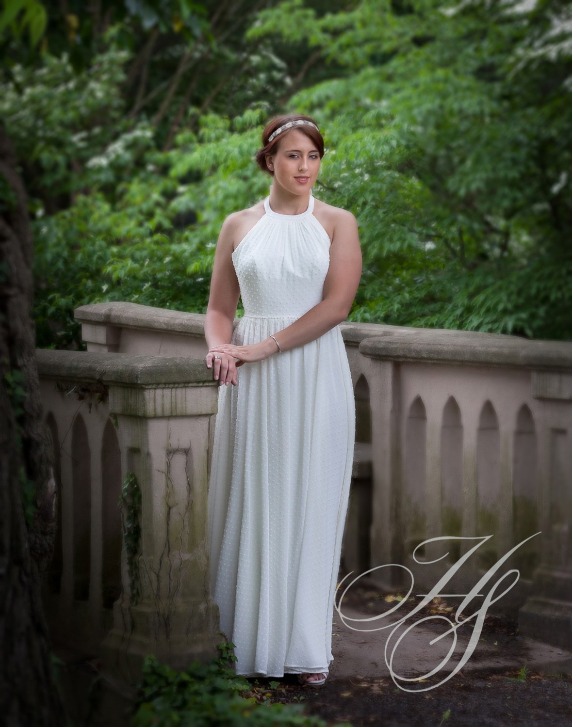 A woman in white dress standing on steps.