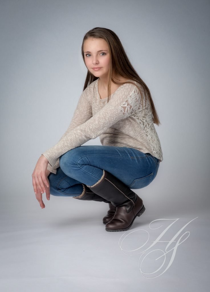 A woman squatting in the middle of her legs.