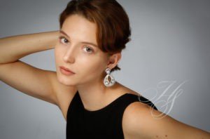 A woman with short hair and wearing earrings.