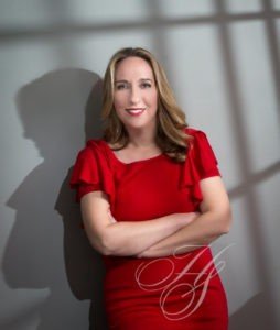 A woman in red dress posing for the camera.