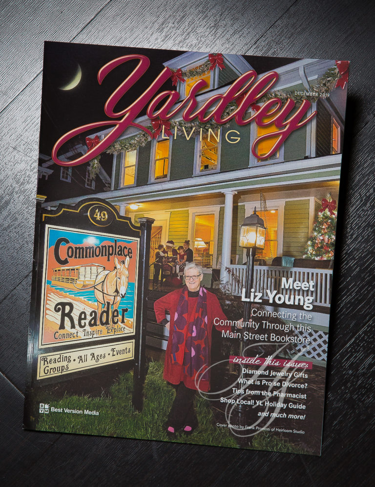 A magazine cover with a picture of a woman in front of a store.