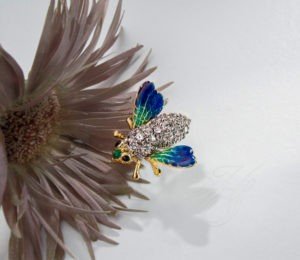 A close up of a bee on top of a flower