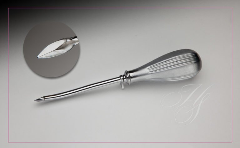 A metal whisk sitting on top of a counter.