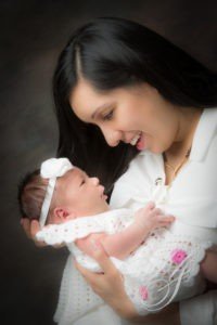 A woman holding a baby in her arms.