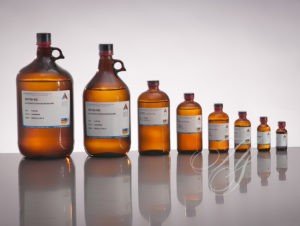 A row of brown glass bottles with labels on them.